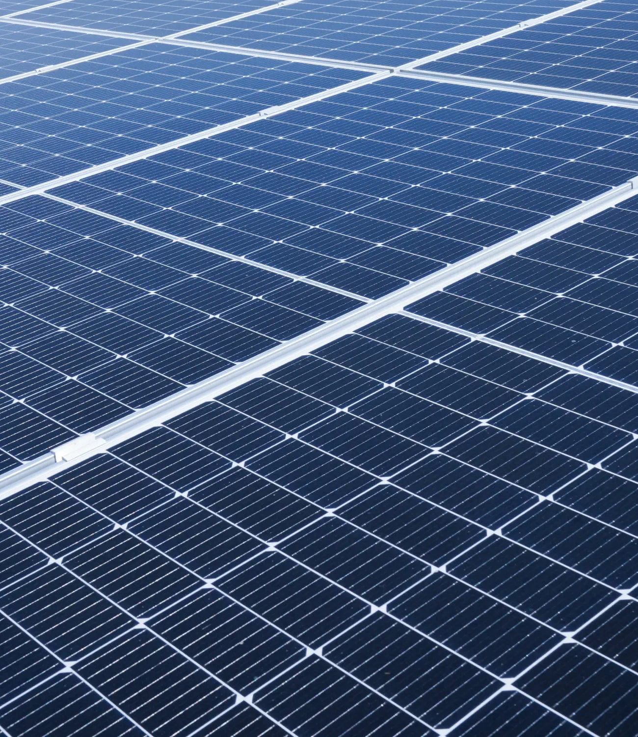 Close-up view of blue solar panels with a grid of white lines.