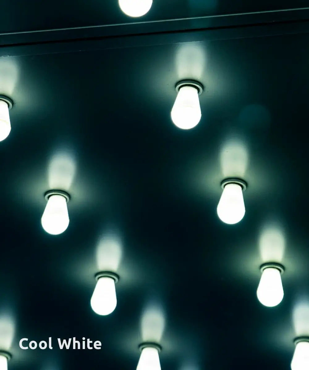 An array of cool white LED light bulbs mounted on a dark ceiling, creating a crisp, modern ambiance with their bright, clean glow.